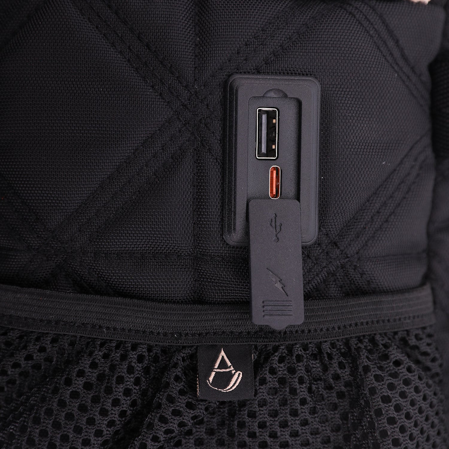 Close-up of Aerolite backpack's USB charging port, highlighting its convenient design for charging devices on the go during travel.