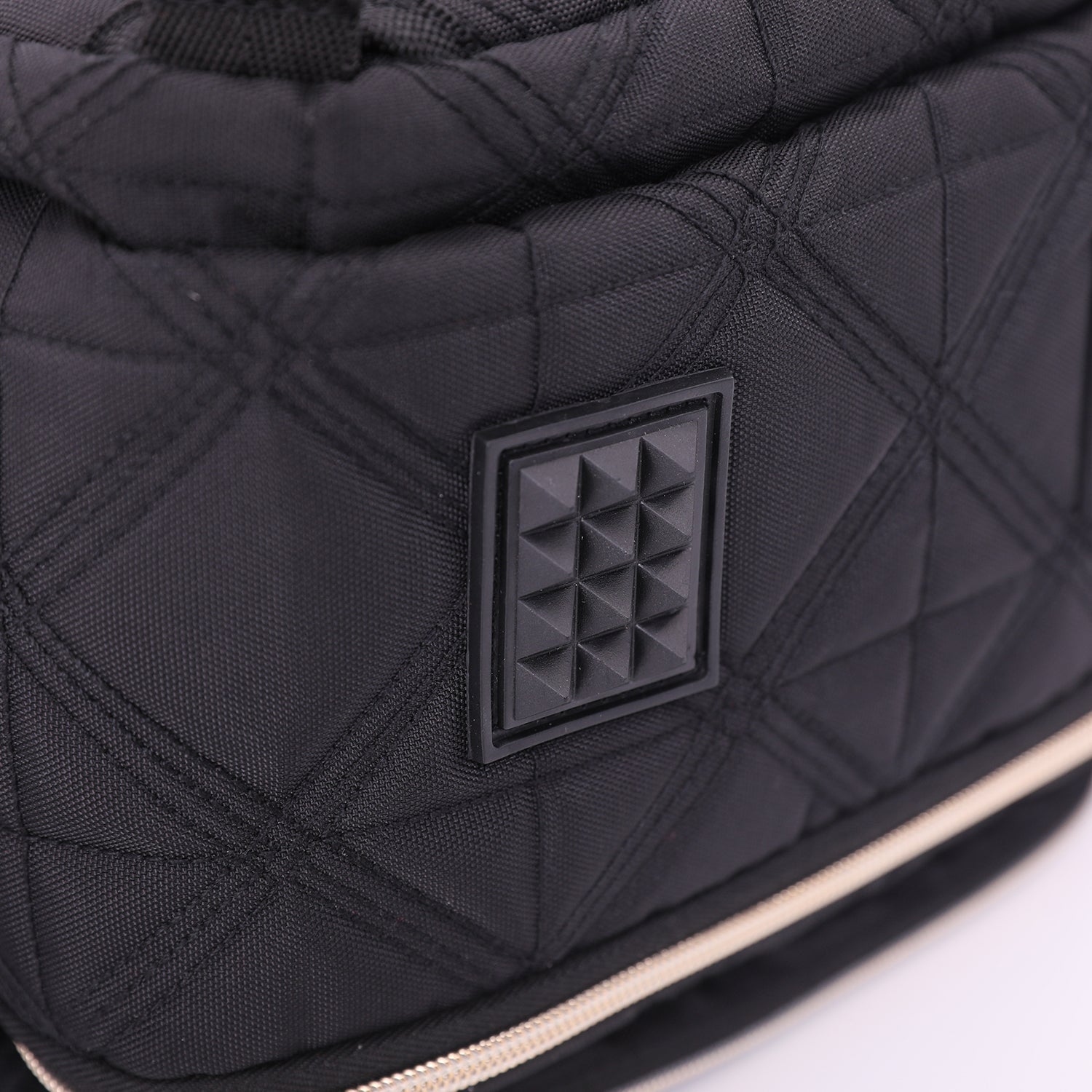 Detailed view of Aerolite backpack's quilted fabric and textured design, showcasing its premium craftsmanship and durable materials.