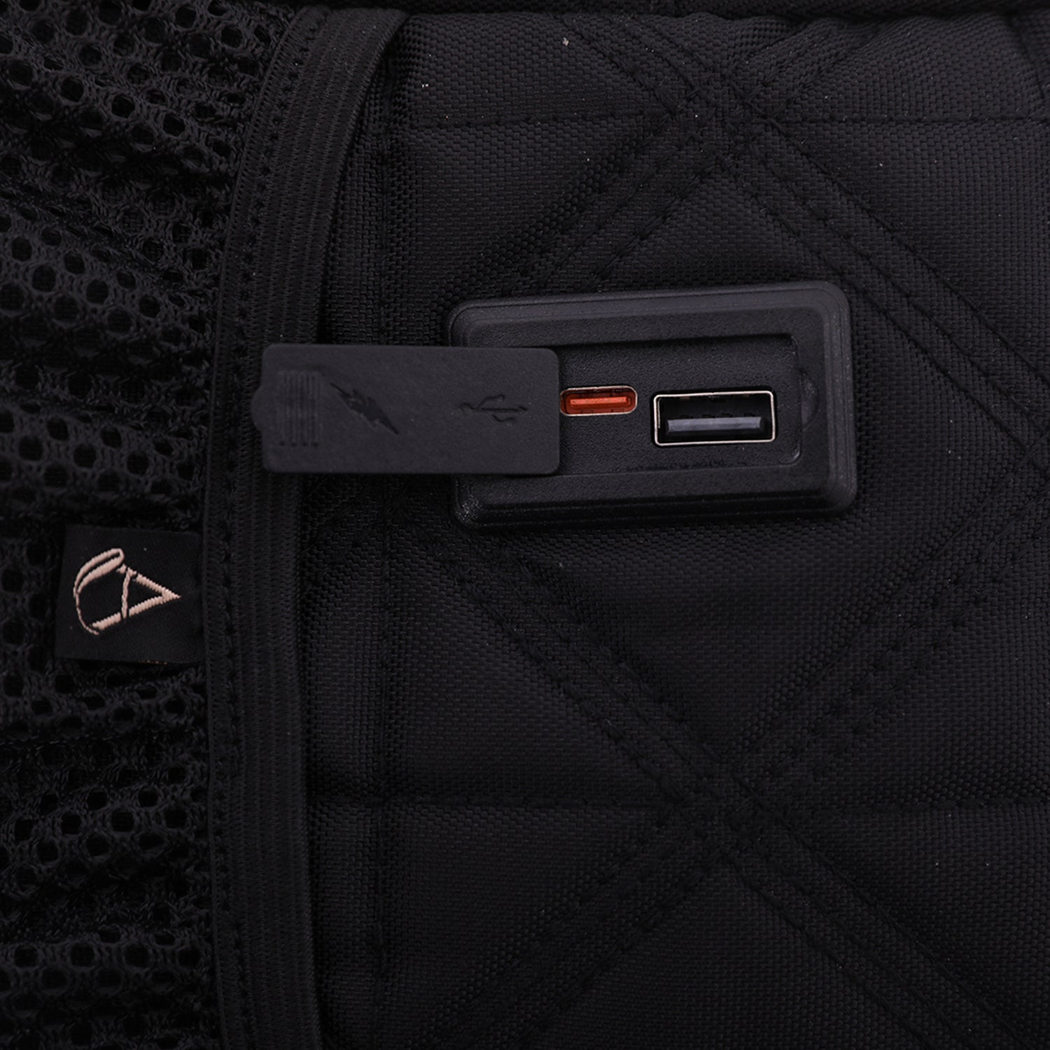 Close-up of the Aerolite 40x20x25cm Ryanair Maximum Eco-Friendly Backpack Trolley Bag showing a built-in USB charging port on a quilted black fabric design.