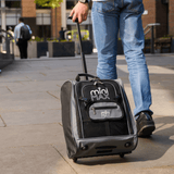 Person pulling Aerolite MiniMAX trolley backpack on street