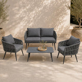 Outdoor furniture set with a sofa, two armchairs, and a coffee table on a patio.
