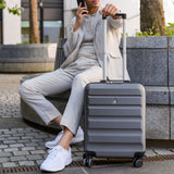 Man sitting with Aerolite suitcase in urban area